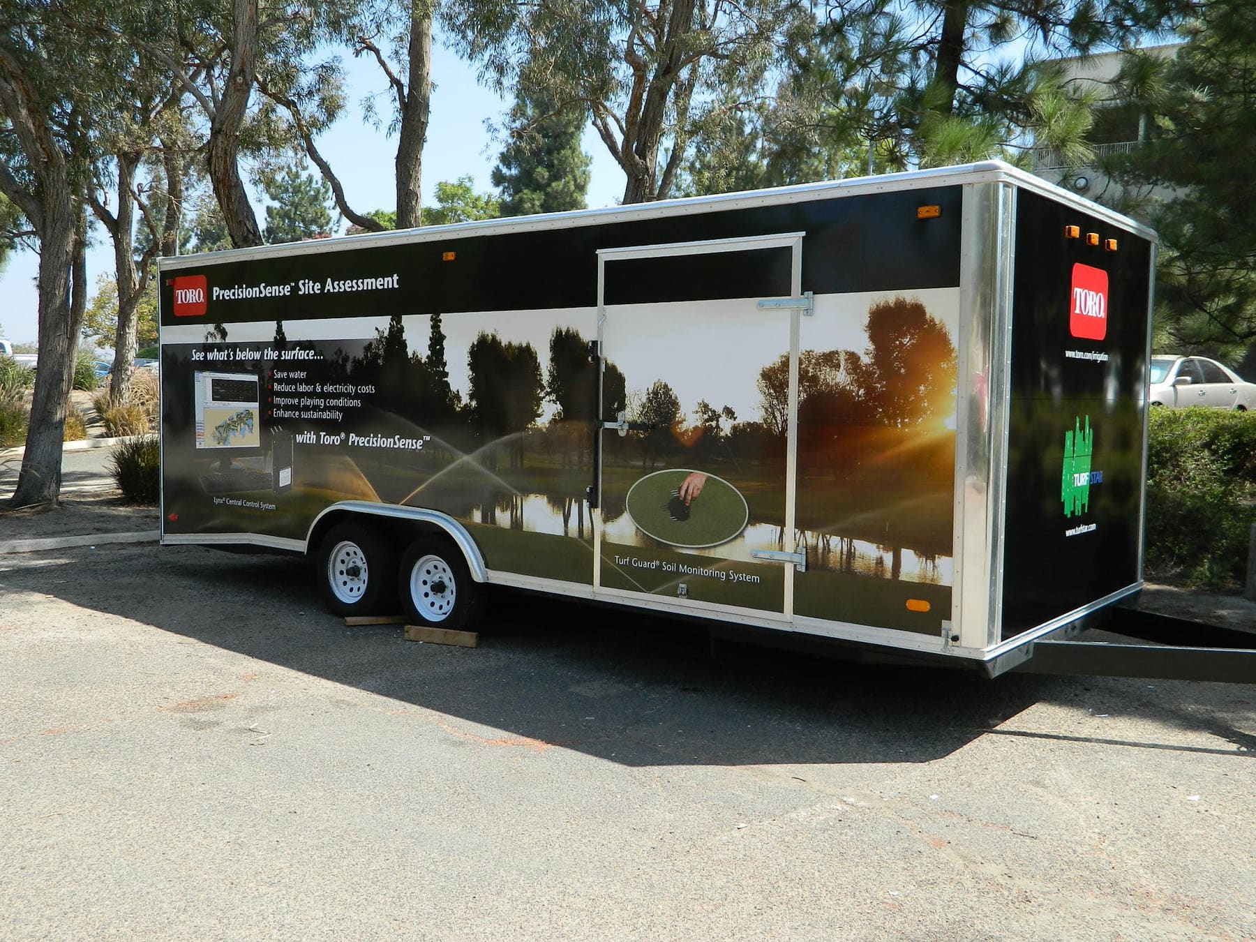 Enclosed equipment trailer wrapped in a full-length turf and irrigation graphic