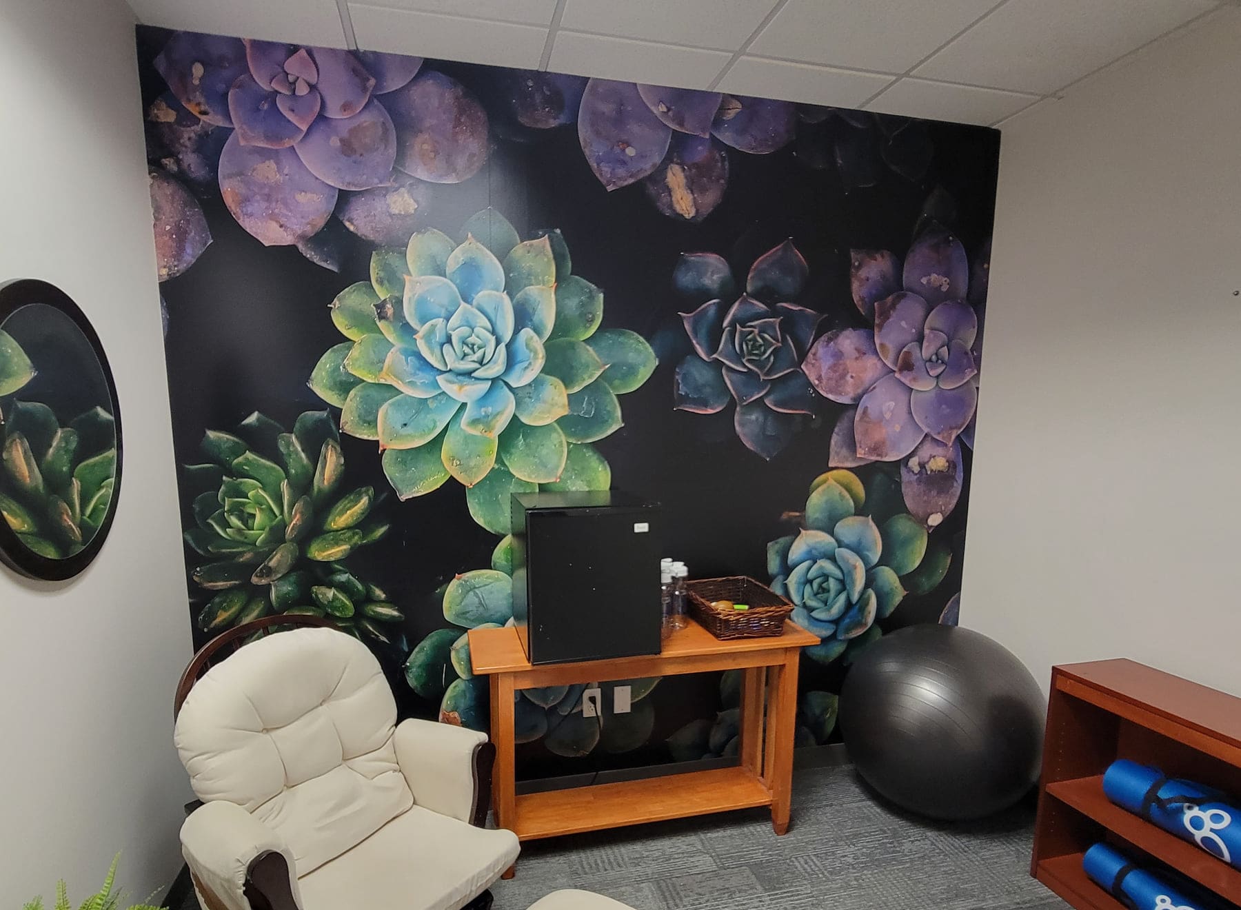 Wellness room wall wrapped in a large printed succulent graphic