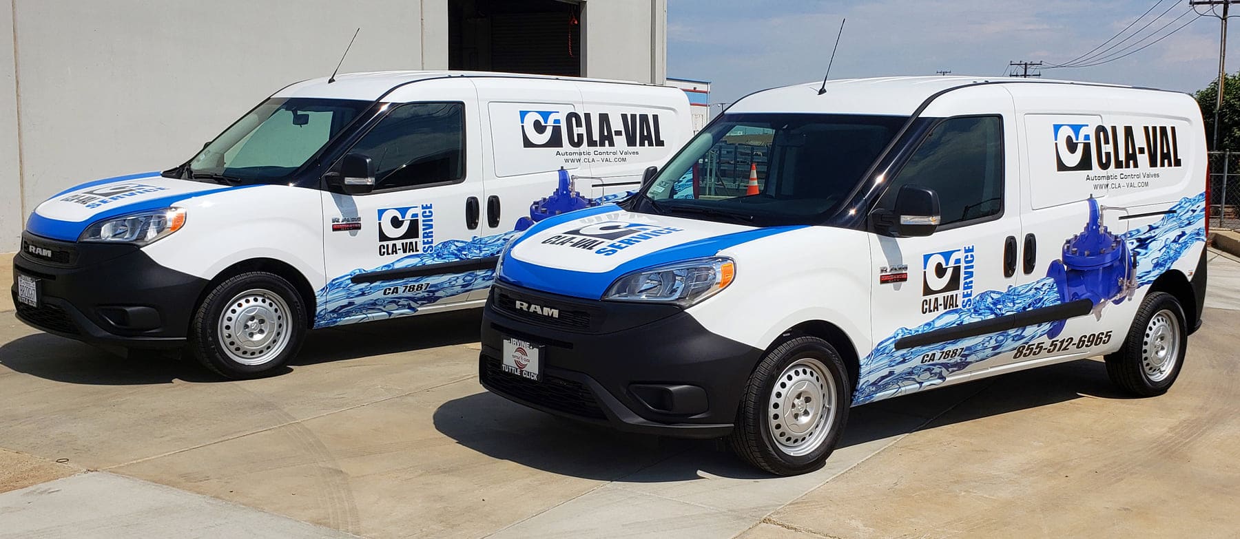 Matching pair of white service vans wrapped with blue water graphics and valve photography for a water control valve company