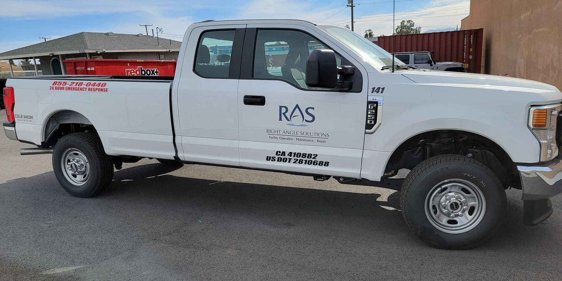 White work truck with cut vinyl door lettering, logo, and regulatory decals